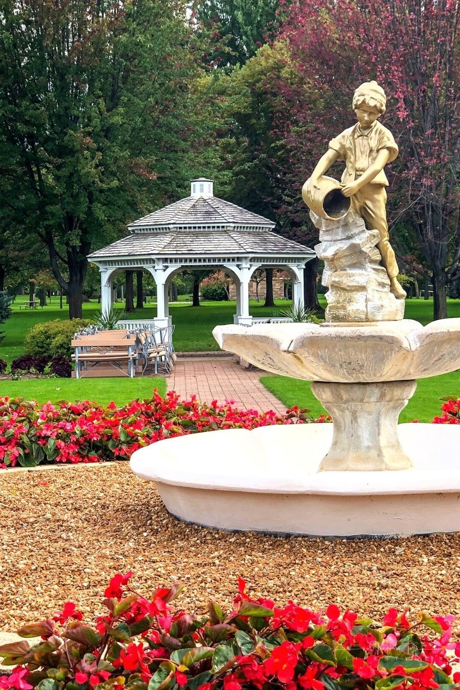 white gazebo with water fountain in forefront