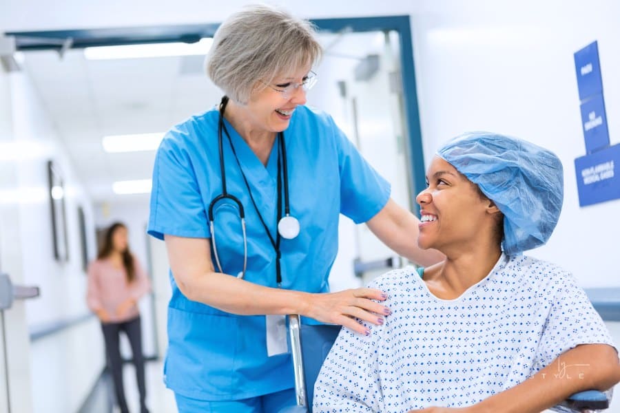 Nurse taking patient to recovery after outpatient surgical procedure