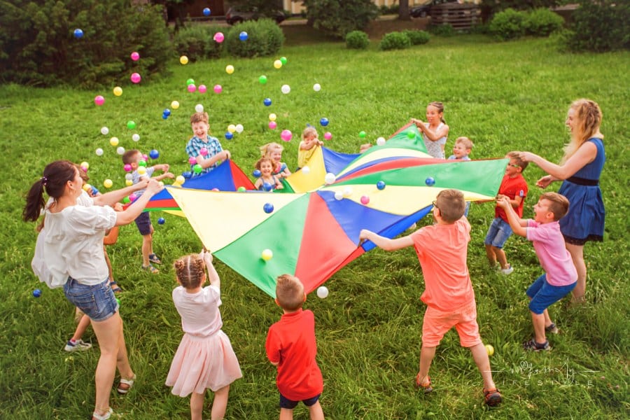 Preschool Kids and Parents Playing with Parachute at the Park
