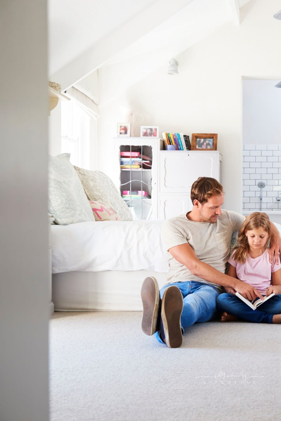 father reading eading a book to daughter