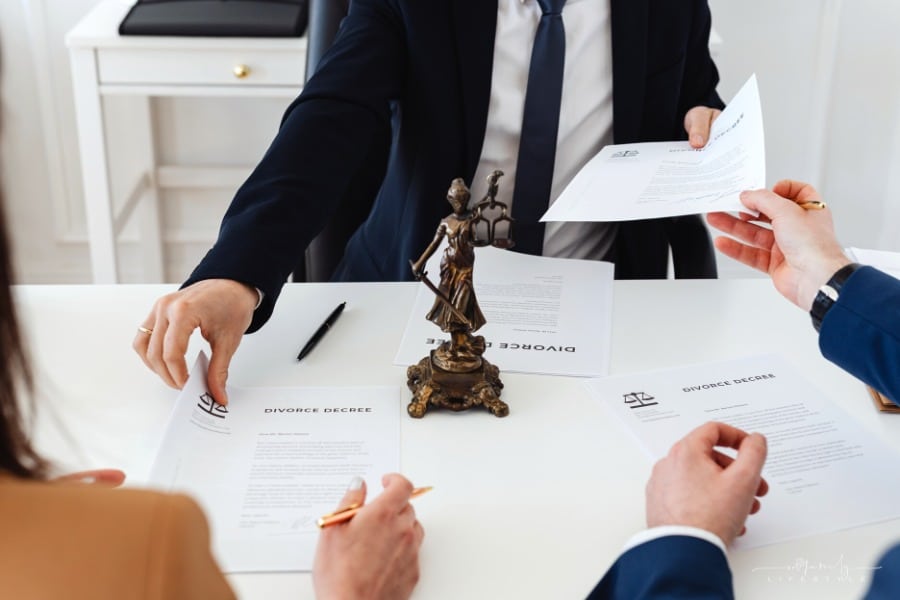 couple signing divorce decree with family lawyer