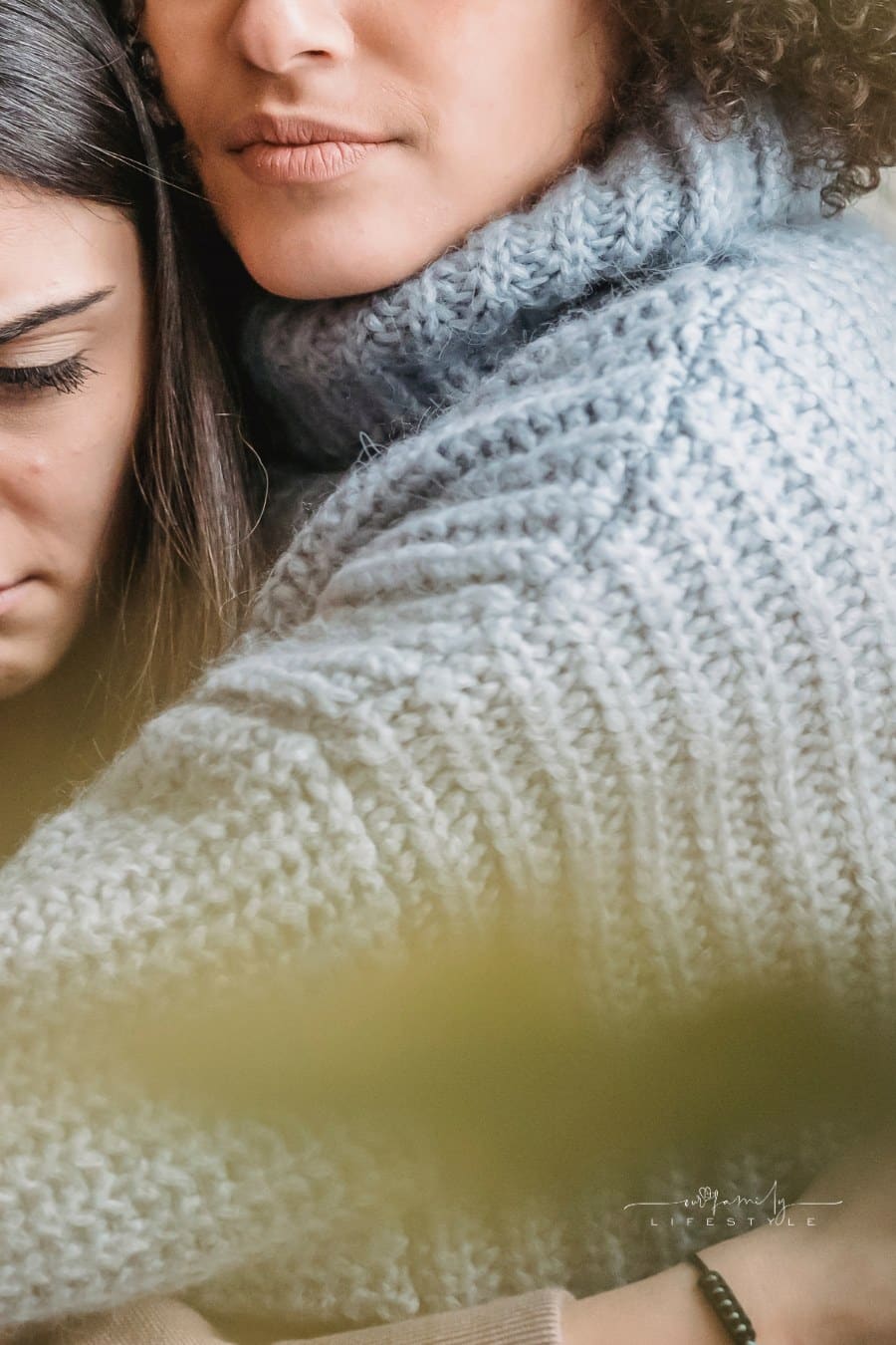 mother hugging daughter before she leaves for college