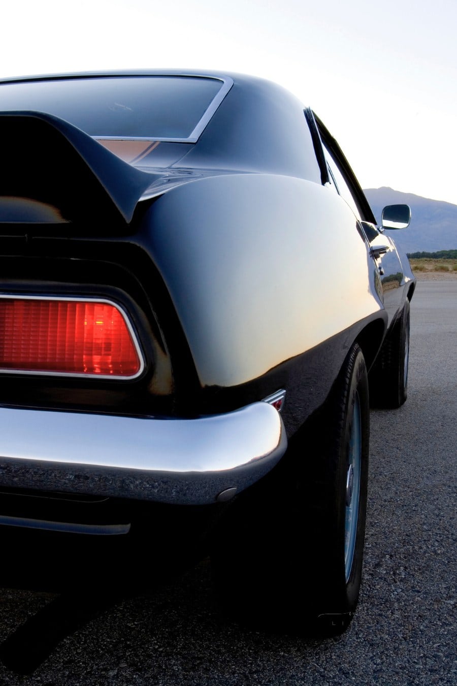Close-up of the rear of a black and gold American muscle car