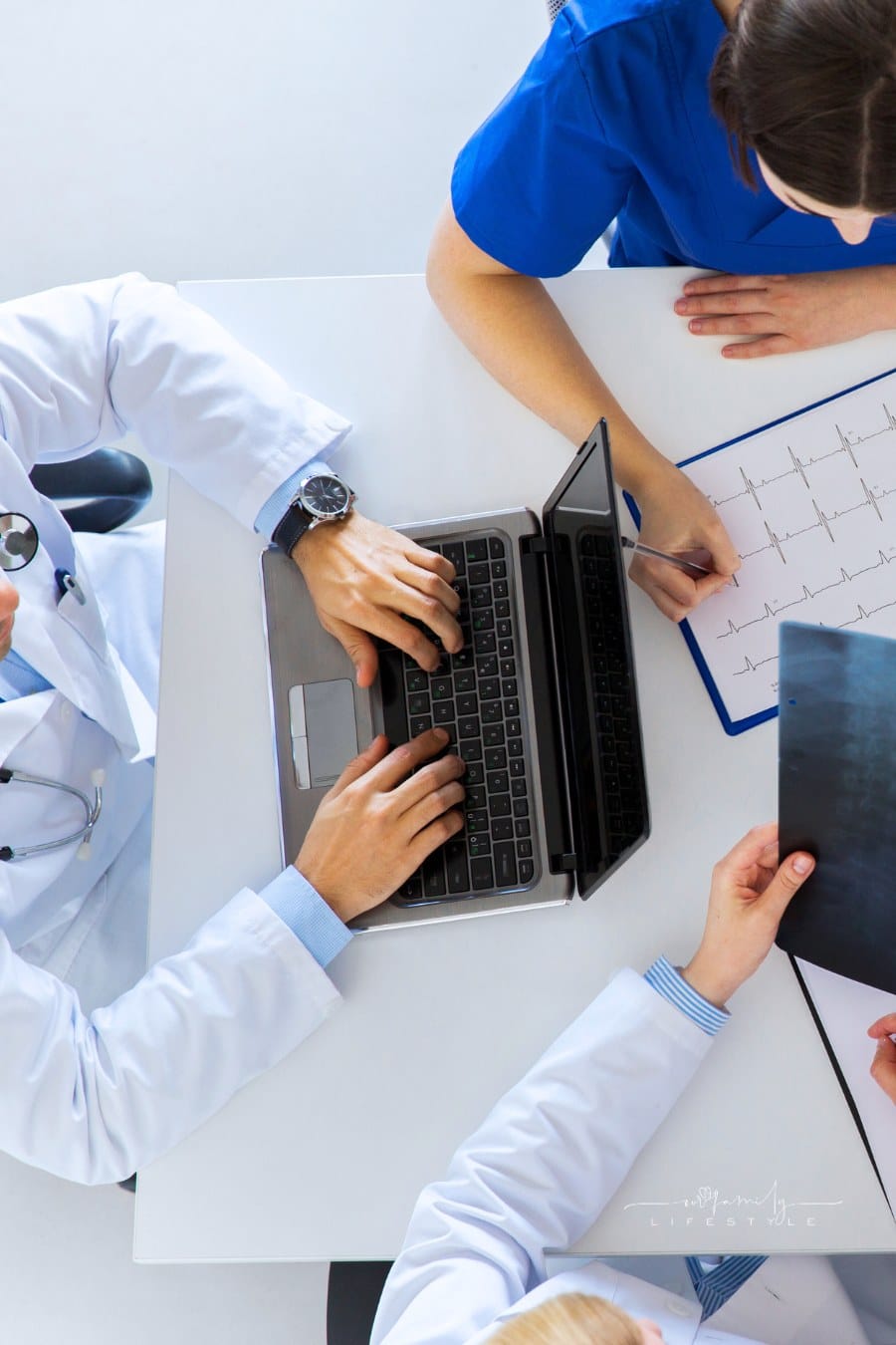 Doctors with X-Rays and Test Results at Hospital