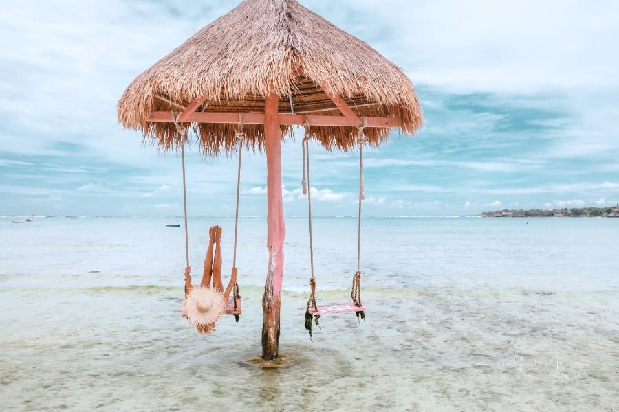Female Traveler on Beach Swing on Bali Island