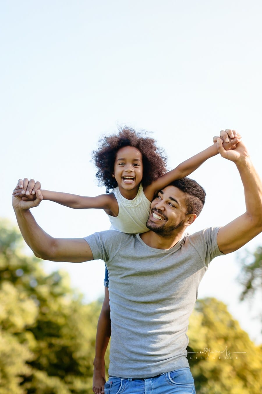 Father carrying daughter on back outdoors