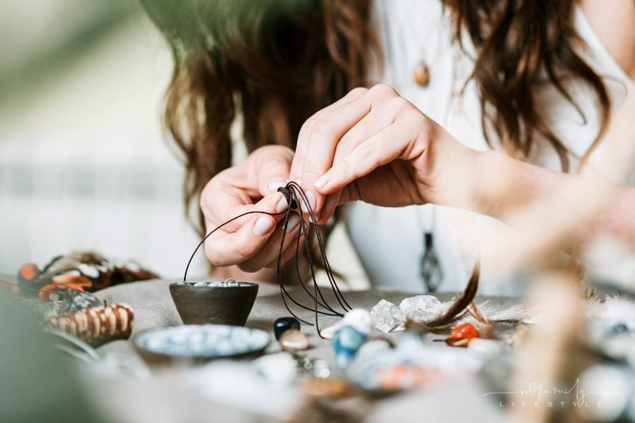 woman making handmade jewelry
