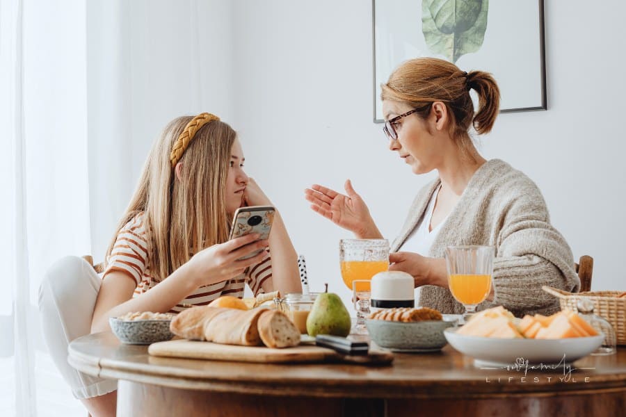 Mother Talking to her Daughter at Breakfast Table