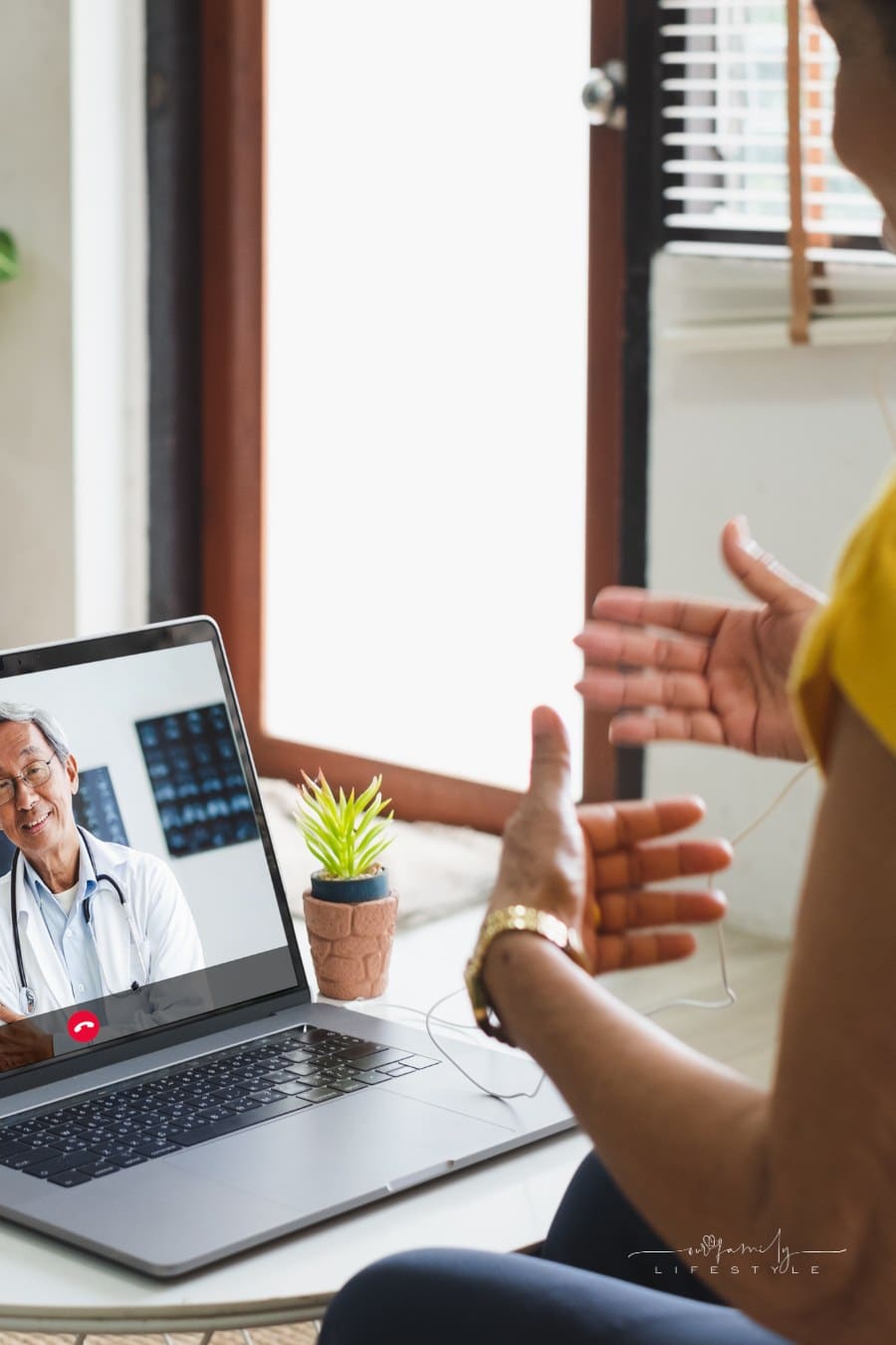 female patient on telehealth call with doctor from chair