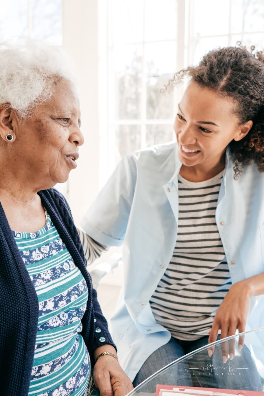assisted living care provider talking to senior woman