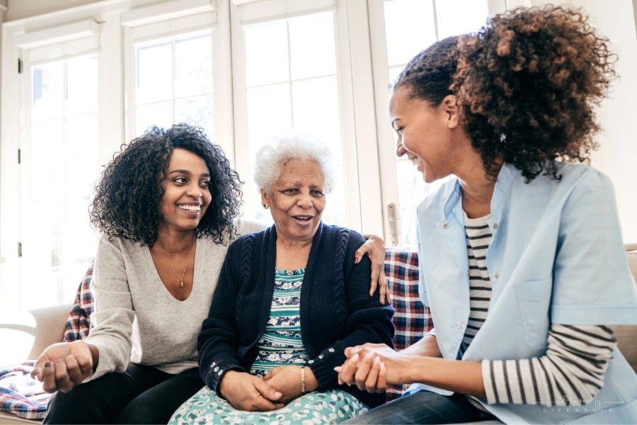 caregiver of senior parent talking to assisted living care provider
