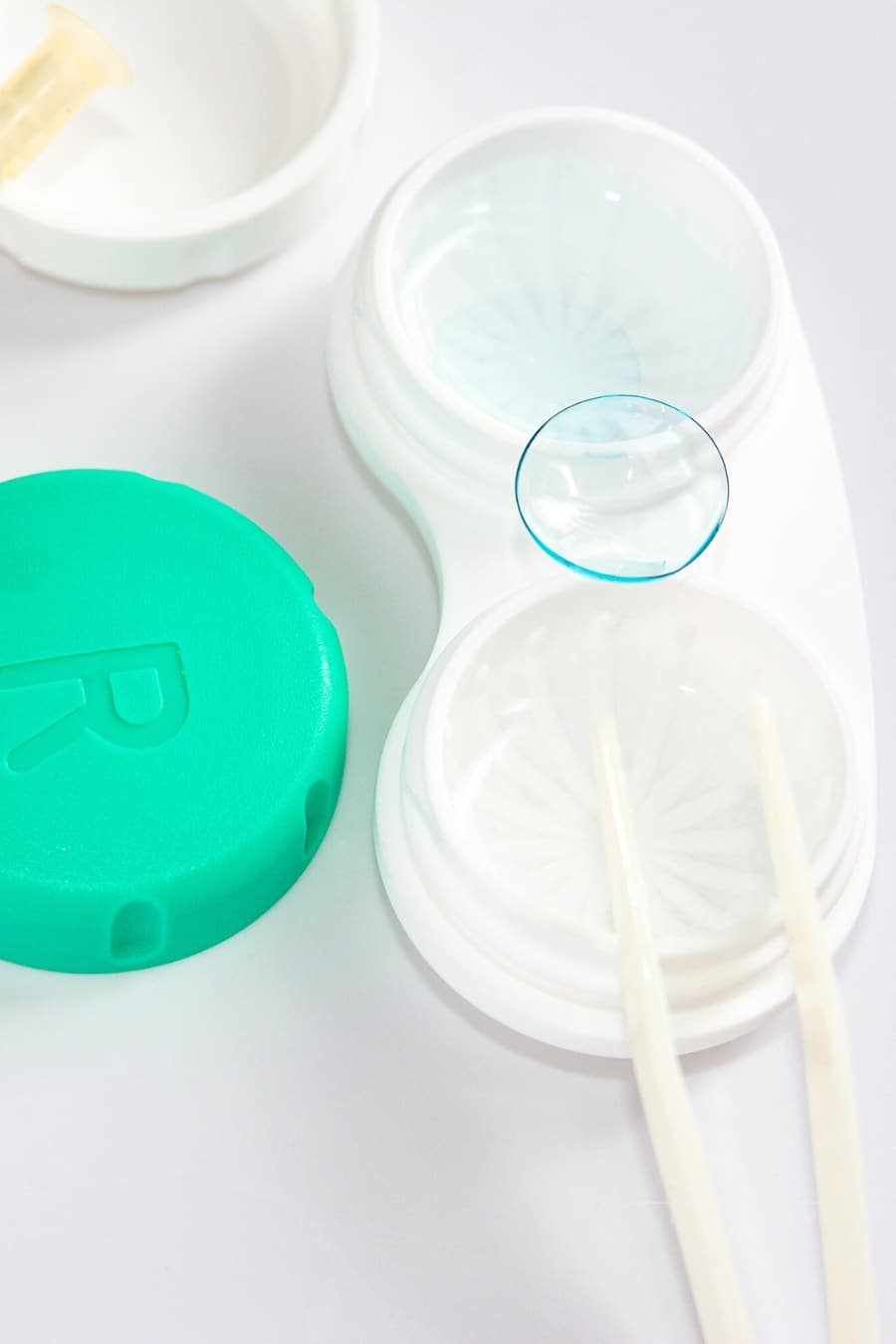 container for soft contact lenses with one contact laying on top