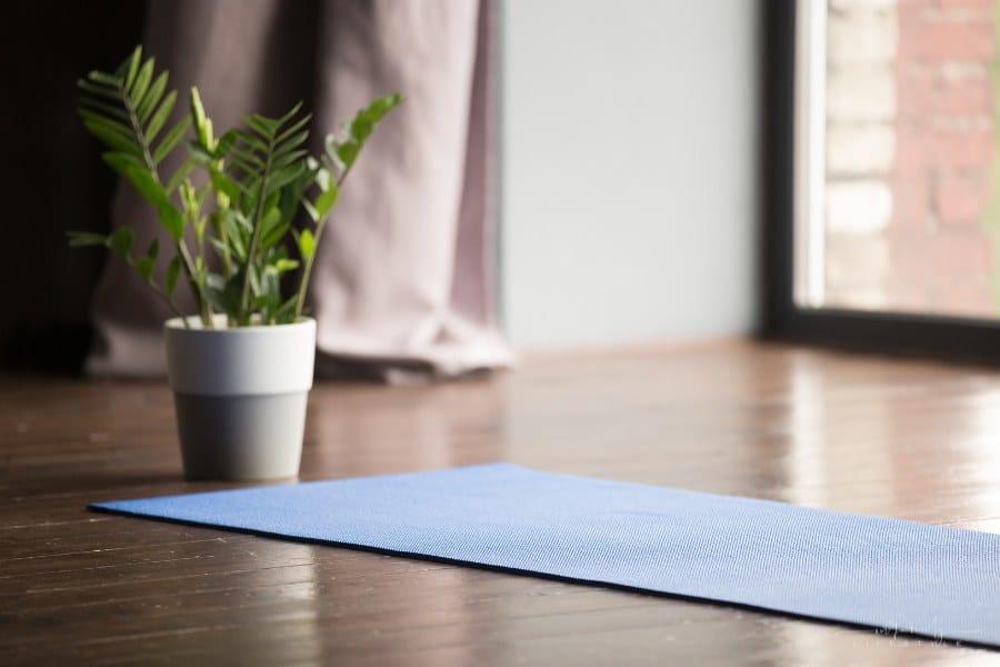 padded prayer mat unrolled in empty room