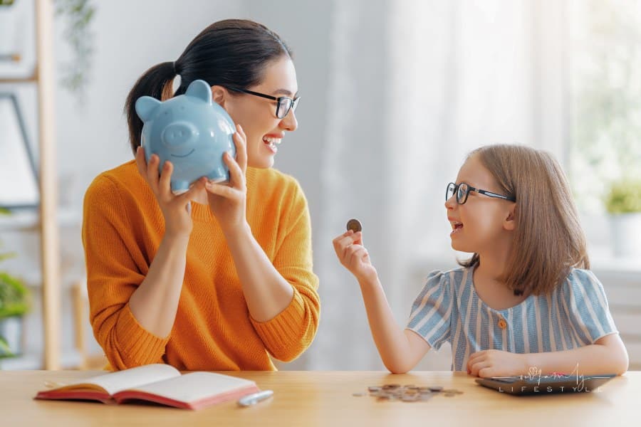 Woman and child sitting at desk with a piggy bank are calculating expenses, managing the family budget.