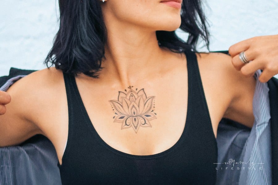 Woman in Black Tank Top Pulling on a Shirt