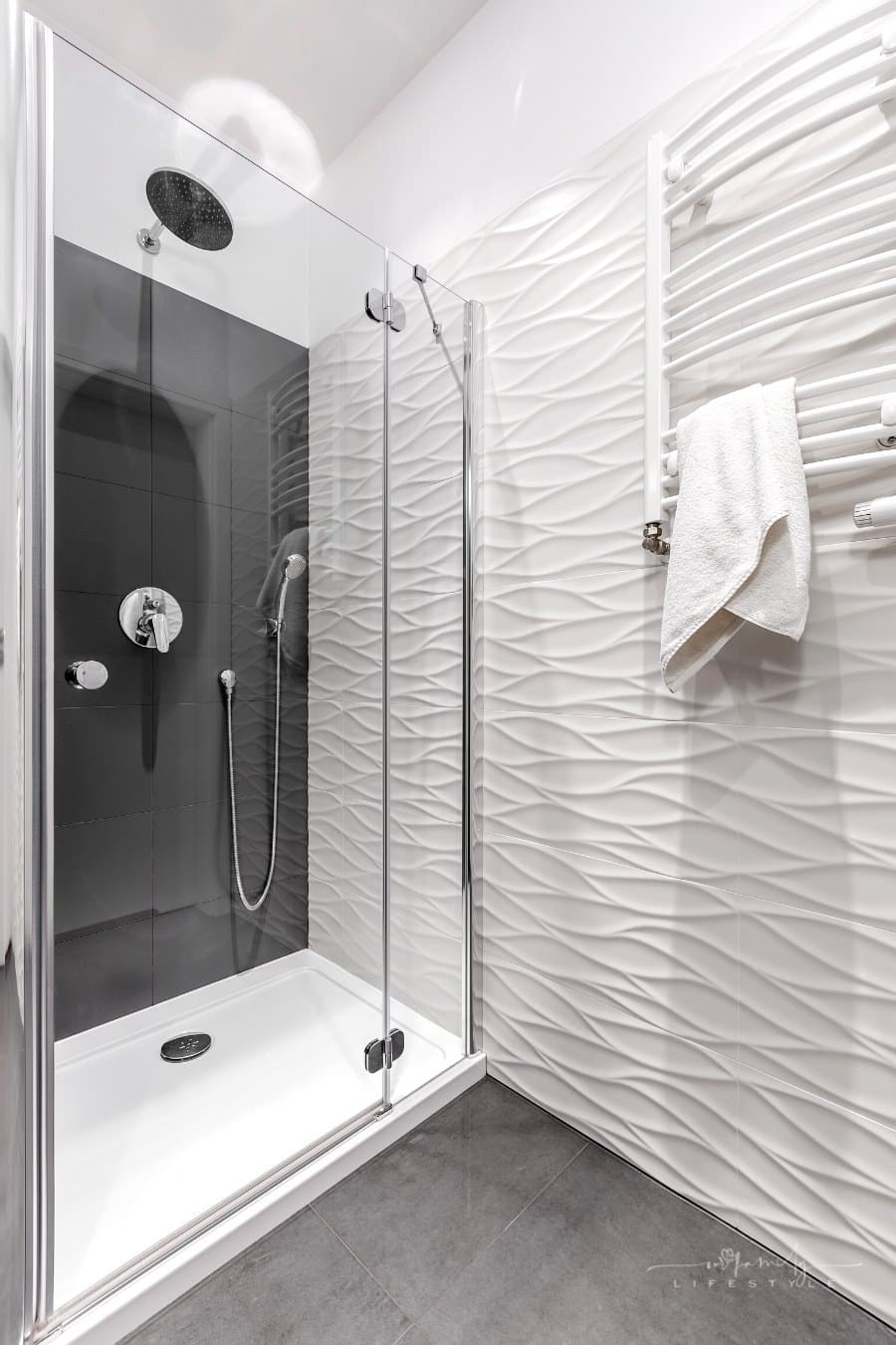 luxury shower with rain head and heated towel rack