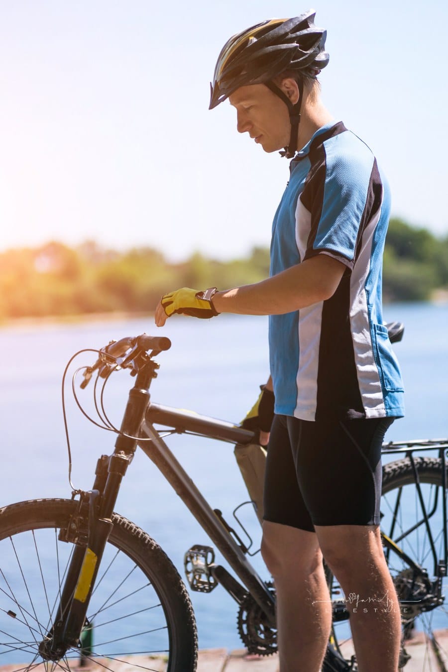 Bicyclist relaxing with bike on a Sunny summer day