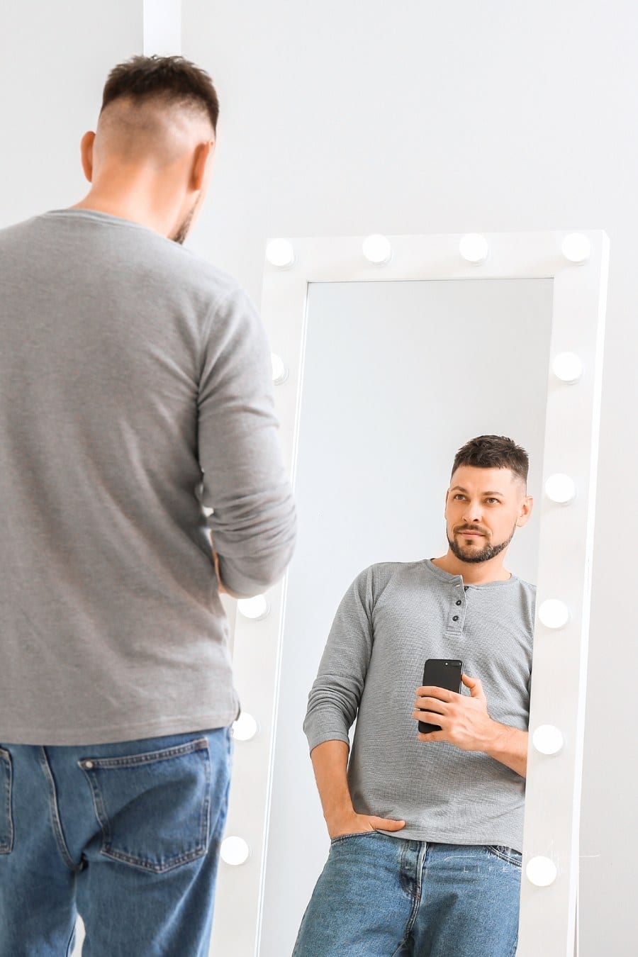 Man Admiring HImself While Taking Selfie in a Mirror at Home