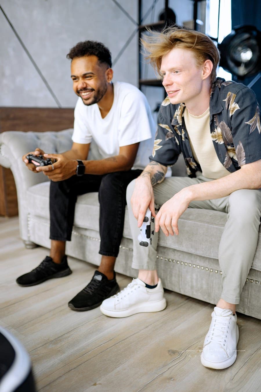 Man in White Crew Neck T-shirt Sitting on Gray Couch