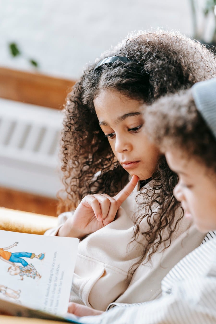 Focused kids reading a book together
