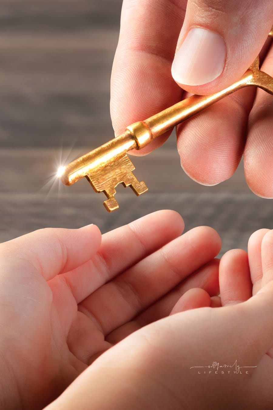 Hand Of Father Giving Old Golden Key To Child - Inheritance Concept