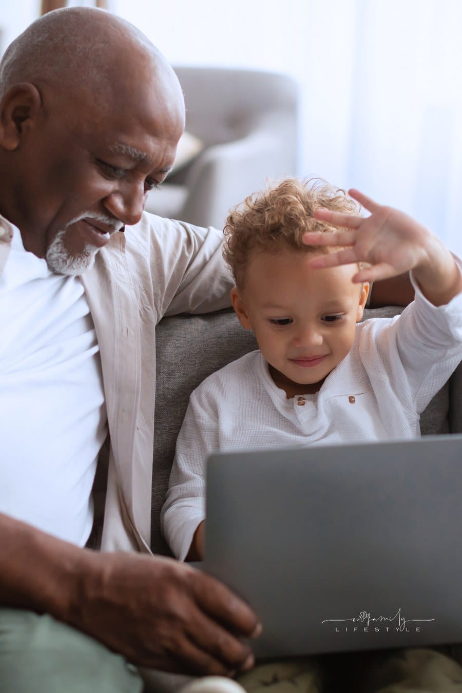 African American Grandpa And Grandson Video Calling Via Laptop Indoor