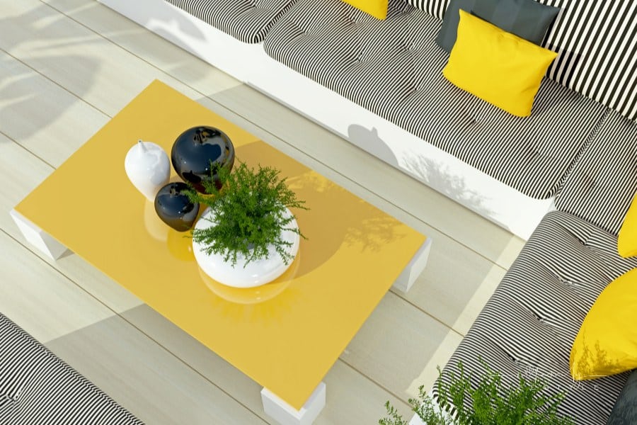 Outdoor patio seating area with big sofa and table.