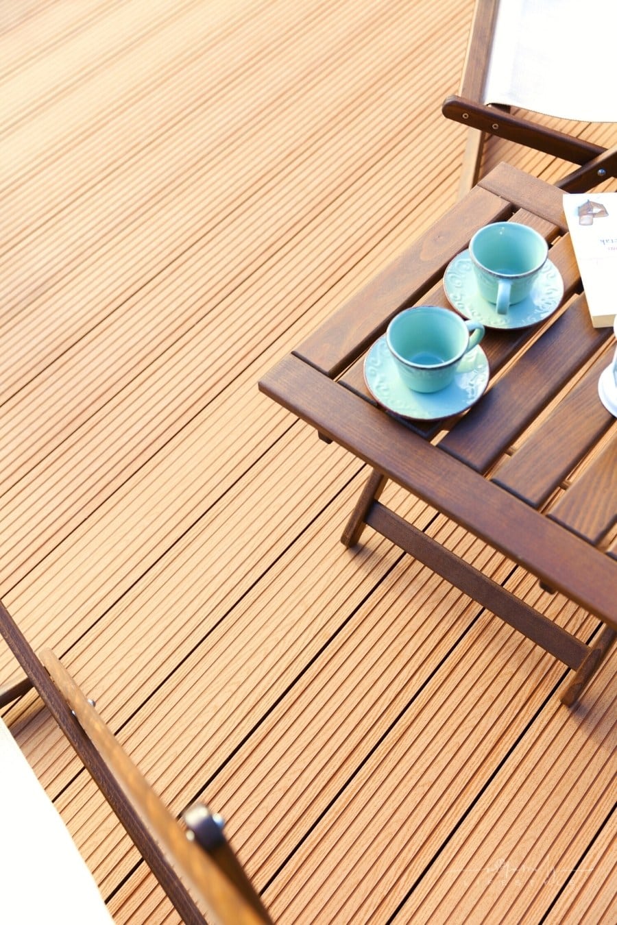 close up overhead view of wooden deck and chairs