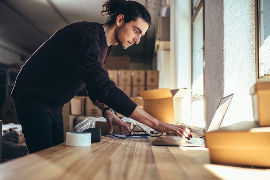 entrepreneur checking order on laptop