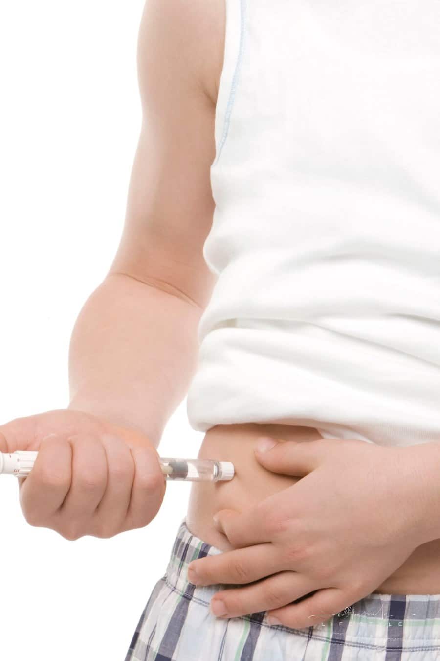 diabetes patient sticking needle full of insulin into stomach