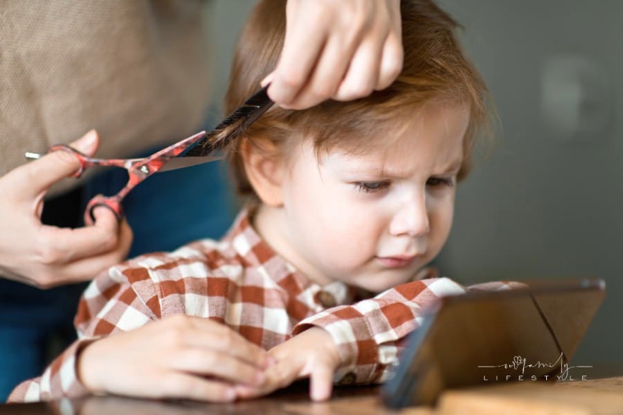 Mom Giving Toddler Son a Haircut at Home