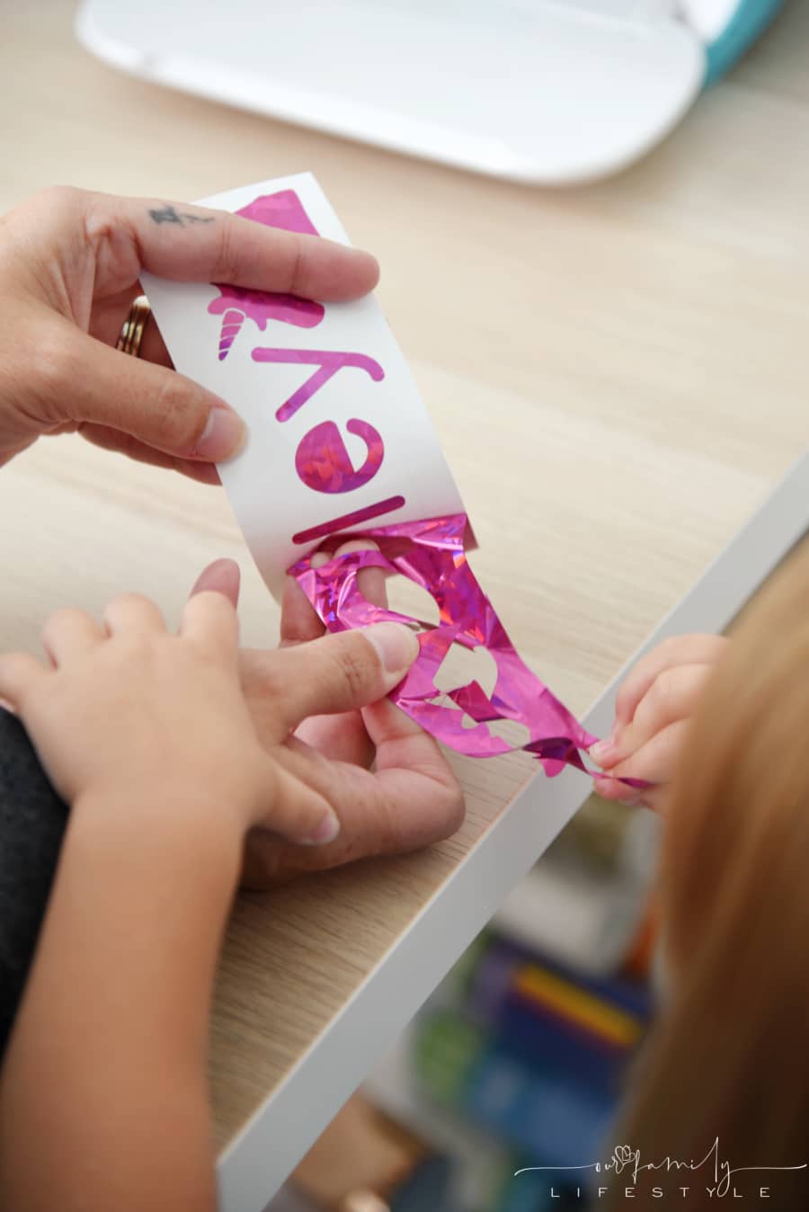 toddler helping weed permanent Cricut vinyl