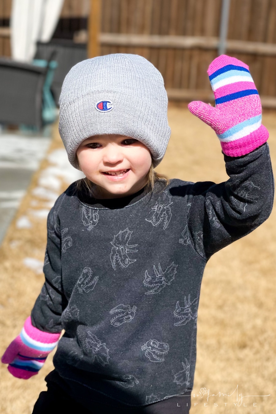 toddler playing in winter with beanie and mittens on