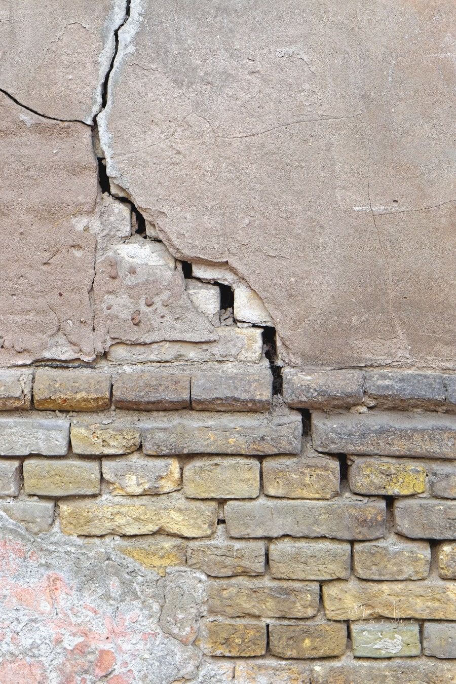 cracked exterior brick wall of house