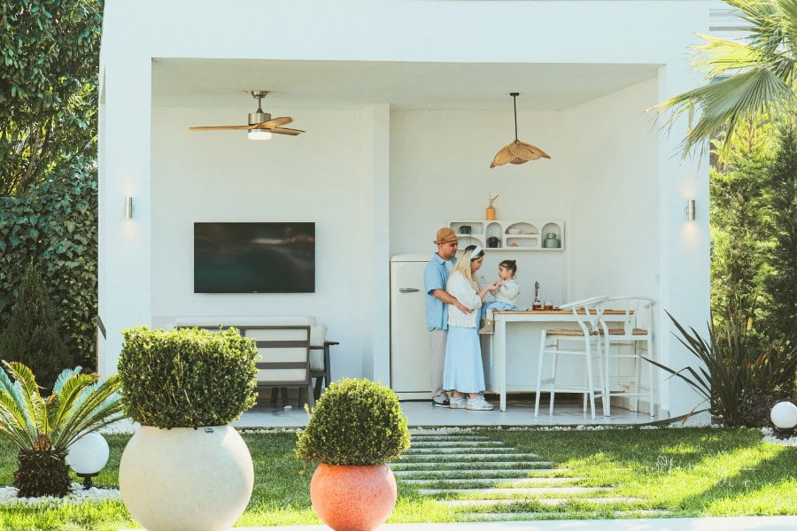 family of three in backyard kitchen space