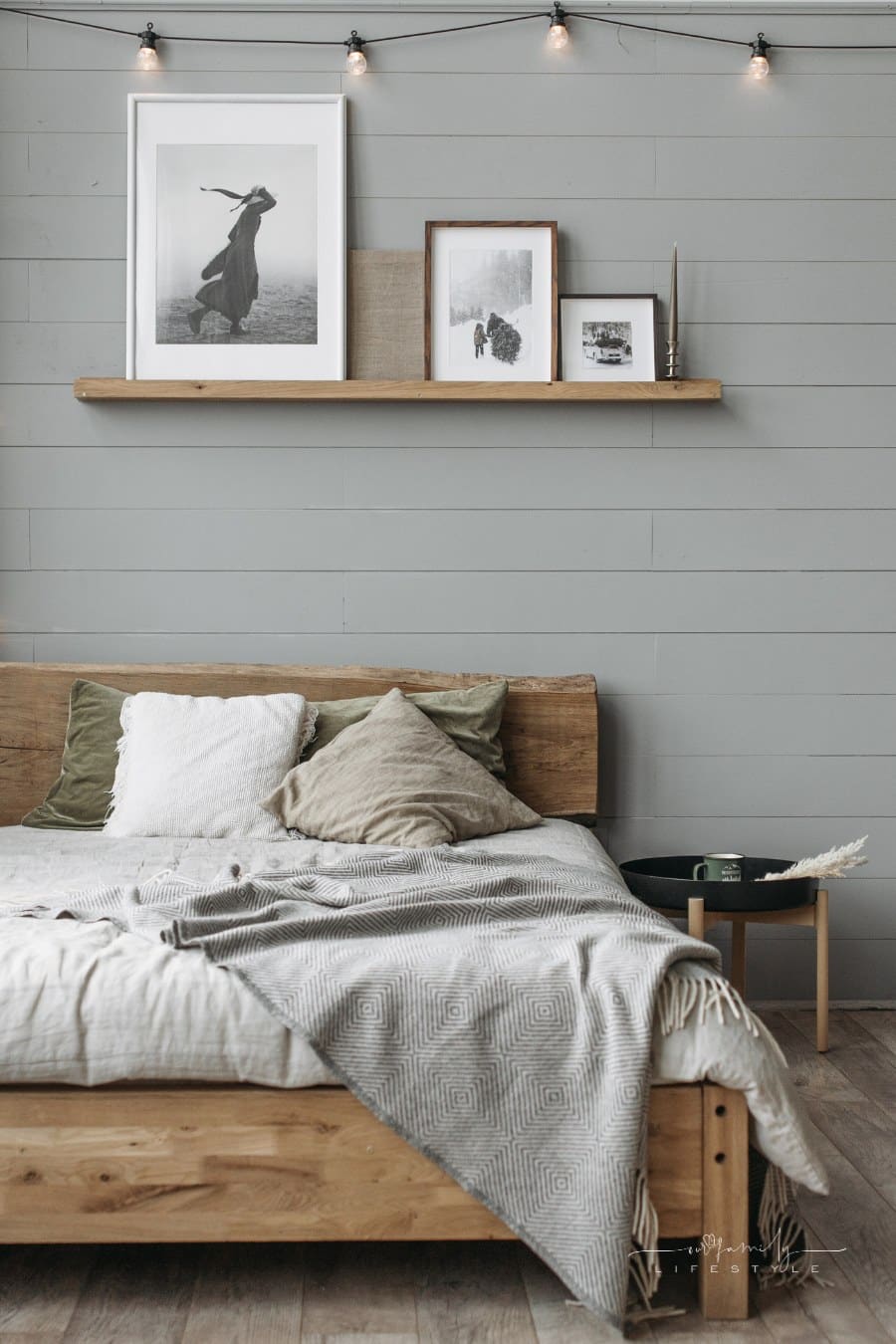 master bedroom with  gray shiplap accent wall and wooden Floor