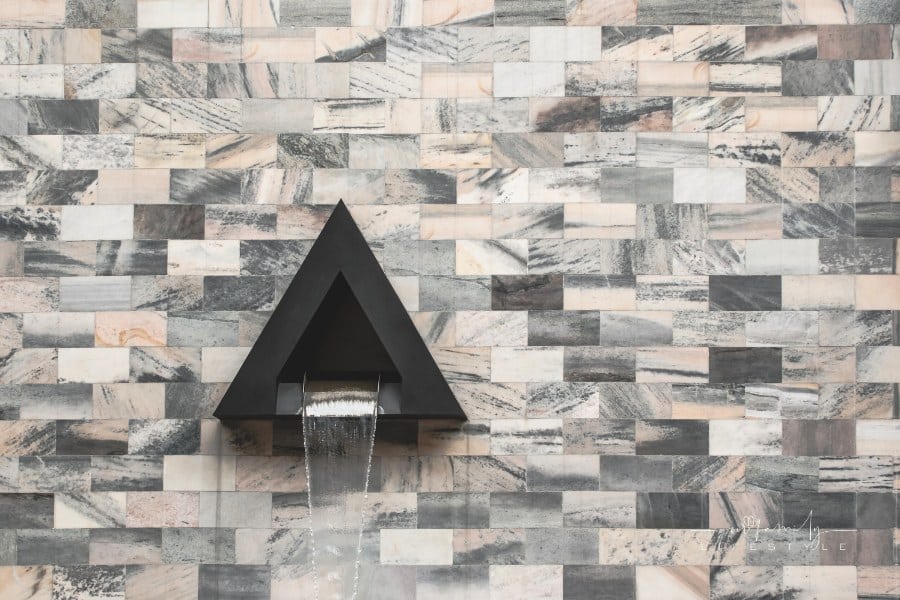 triangular wall fountain on tiled wall
