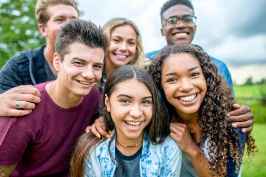 group of teens smiling together at camera