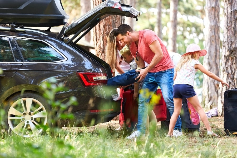 family at the car loading trunk with luggage