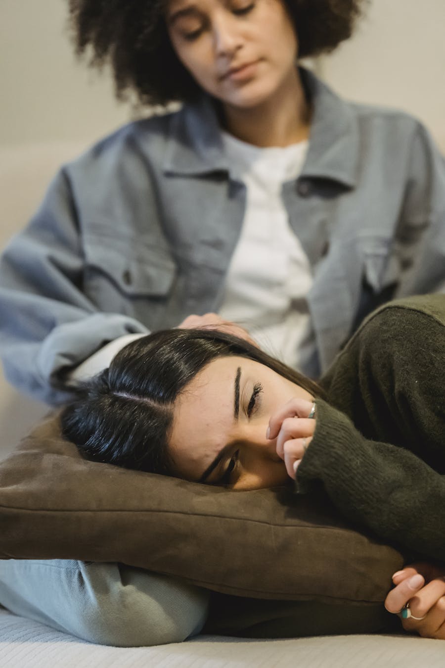 Two women in a comforting scene, depicting friendship and emotional support.