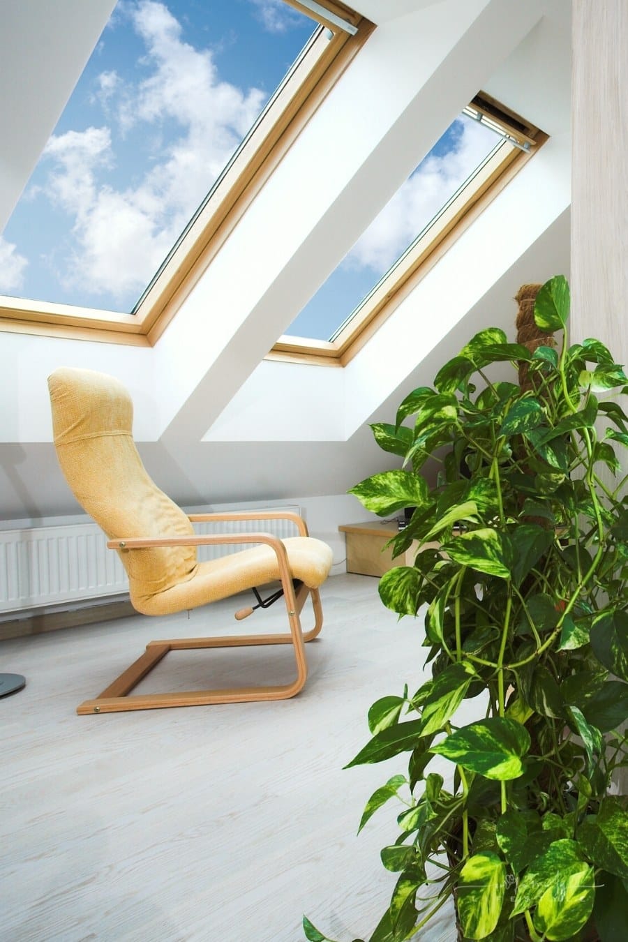 attic living room with two skylights