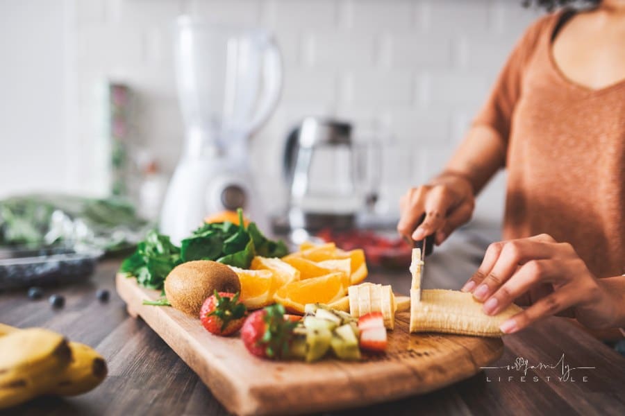Cropped shot of a young woman making a healthy snack with fruit at home