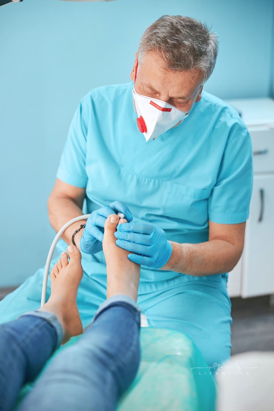 podiatrist wearing gloves while removing pain in toes of a female foot