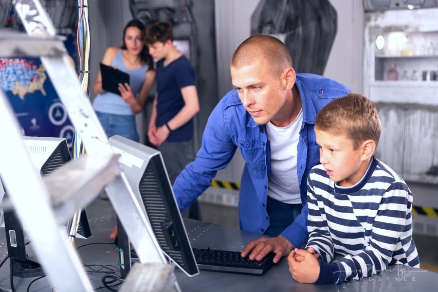 dad and son on computer trying to find solution to escape room puzzle