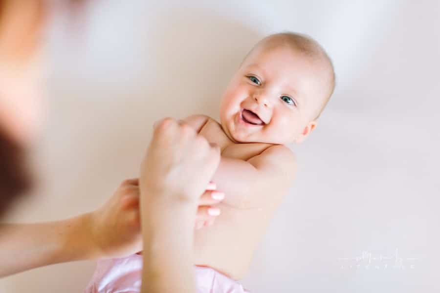 Baby massage. Mother massaging and doing gymnastic with arms of her kid