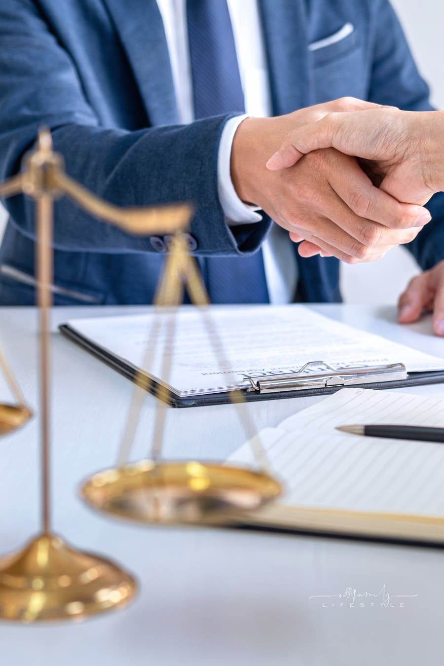 lawyers shaking hands over contracts