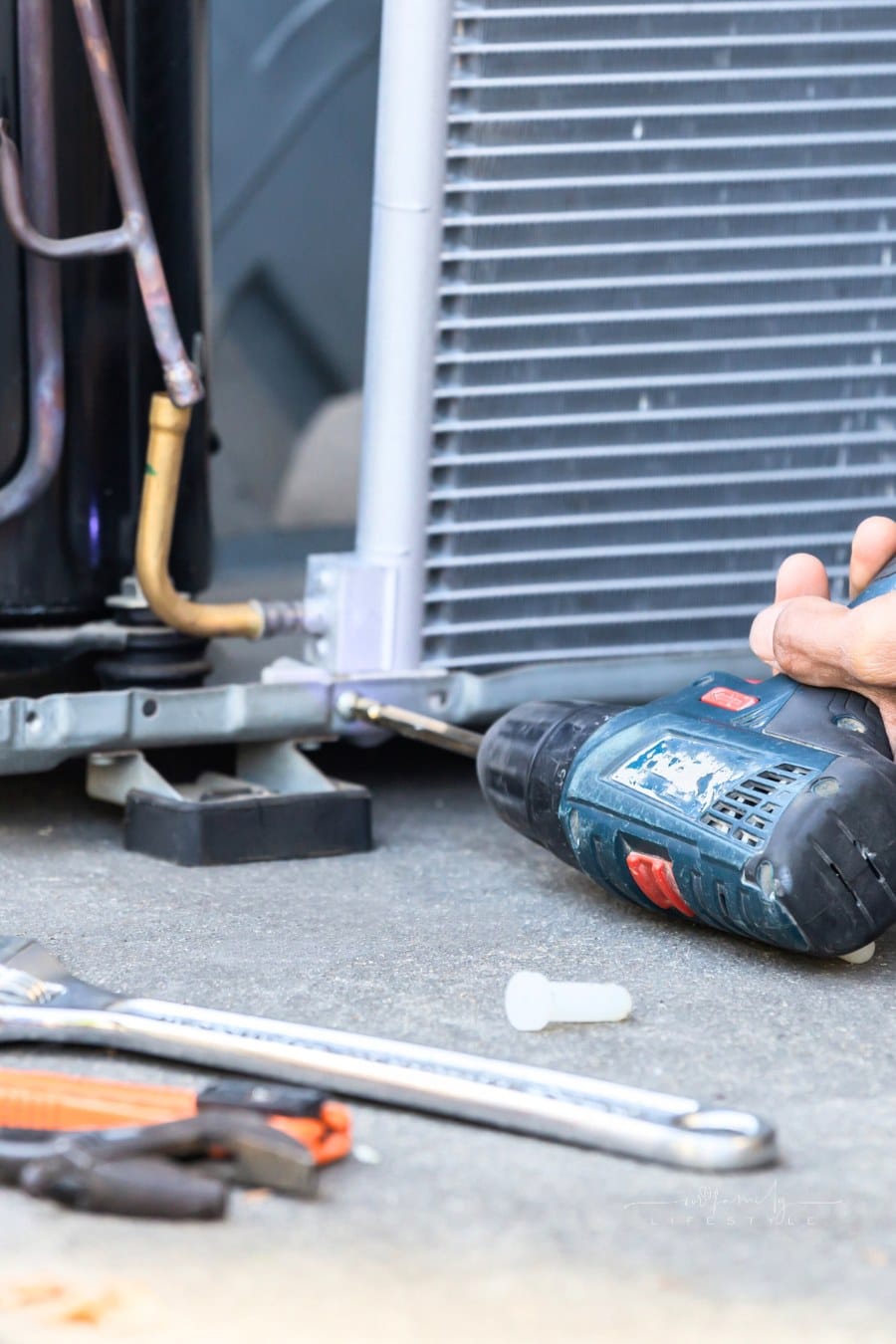 Selective focus Air Conditioning Repair, technician man hands using a screwdriver fixing modern air conditioning system