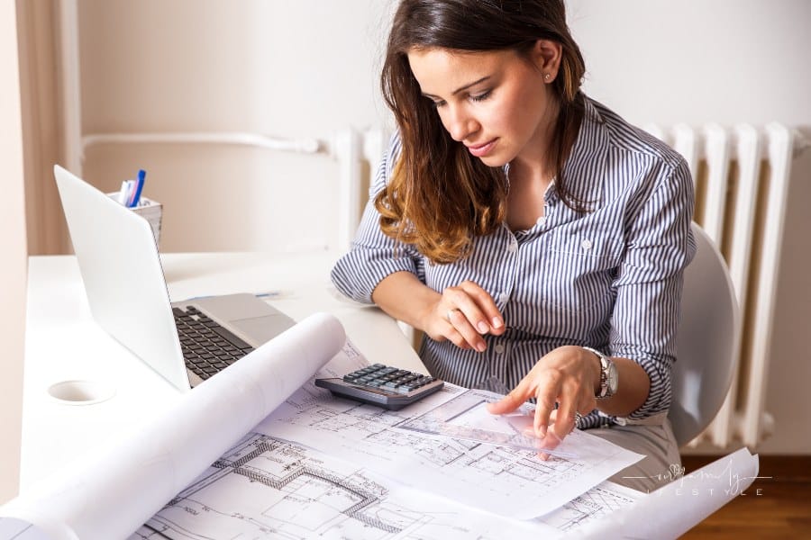 Female architect looking over blueprints