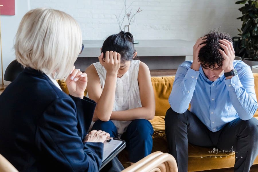Couple with heads in their hands during Therapy Session