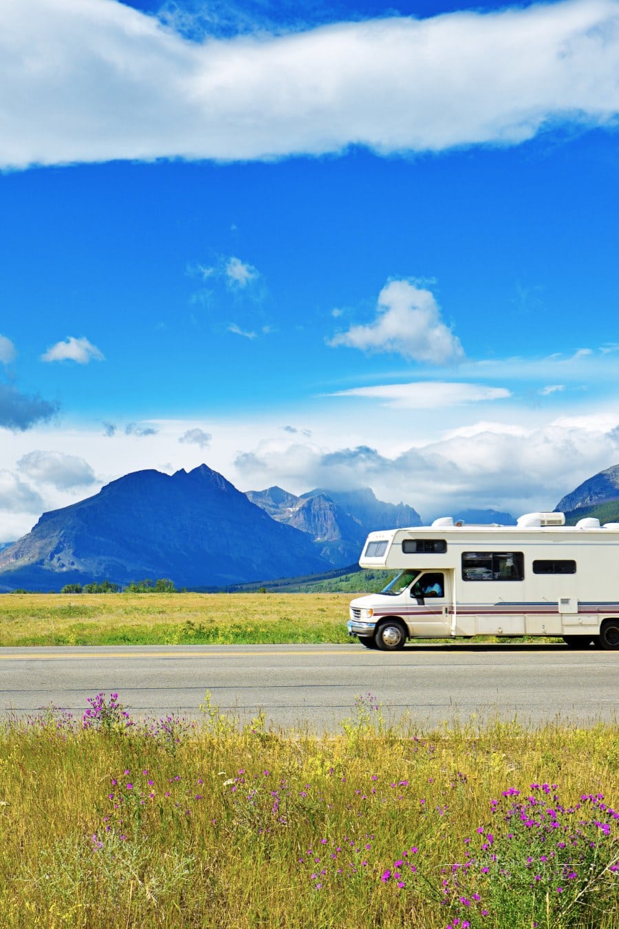 Glacier National Park, Montana, USA. Visitors in camper RV traveling to Glacier National Park touring the park along the breathtaking 'Going To The Sun Road'. The scenic road wind through the national park along steep mountain cliffs and valleys.